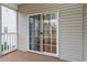 View of a sliding glass door leading from a tan carpeted porch to a wood-floored interior space at 130 Lazy Willow Ln. # 204, Myrtle Beach, SC 29588