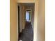 Hallway view with neutral walls leading to the front door, showing the layout of the home's interior at 1353 Moss St., Georgetown, SC 29440