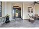 Inviting front porch with rocking chairs, decorative accents, and a stylish entrance door at 1428 Whooping Crane Dr., Conway, SC 29526