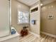 Bathroom featuring window, white cabinets, wood look floors and a glass enclosed shower at 144 Harbor Lights Dr., Surfside Beach, SC 29575