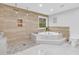 Luxurious bathroom featuring marble floors, corner bathtub, and separate shower with rainfall showerheads at 145 Bendick Ct., Little River, SC 29566