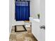 Clean bathroom with a blue shower curtain and a tan-colored floor at 145 Bendick Ct., Little River, SC 29566