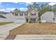 Charming two-story home featuring a well-manicured lawn, inviting front porch, and attached garage at 145 Bendick Ct., Little River, SC 29566