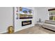 Cozy living room with plank flooring with combined kitchen and fireplace at 145 Bendick Ct., Little River, SC 29566