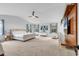 Bright and airy main bedroom features large windows, plush carpeting, and a custom media wall unit at 145 Bendick Ct., Little River, SC 29566