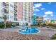 Inviting outdoor pool with brick pavers, lush landscaping, and views of the building at 1605 S Ocean Blvd. # 509, Myrtle Beach, SC 29577