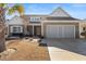 Inviting single-story home featuring a two-car garage, drought-resistant landscaping, and a welcoming entrance at 1685 Sapphire Dr., Longs, SC 29568