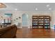 Spacious living room with hardwood floors and a bookcase at 1685 Sapphire Dr., Longs, SC 29568