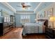 Serene main bedroom with a ceiling fan, shutters, and hardwood floors at 1685 Sapphire Dr., Longs, SC 29568