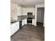 Modern kitchen with white cabinets, granite countertops, stainless steel appliances and wood floors at 175 Glengrove Lane, Murrells Inlet, SC 29576