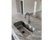 Close up on the kitchen sink with granite countertop and modern faucet in a well-lit kitchen at 175 Glengrove Lane, Murrells Inlet, SC 29576