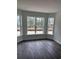 Bright living room with hardwood floors and views of the surrounding trees at 175 Glengrove Lane, Murrells Inlet, SC 29576