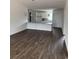 Open-concept living room with hardwood floors and white kitchen with granite counters at 175 Glengrove Lane, Murrells Inlet, SC 29576