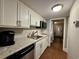 Well-equipped kitchen with white cabinets, granite counters, stainless steel appliances, and a Keurig machine at 201 N 74Th Ave. N # 2322, Myrtle Beach, SC 29572