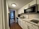 Modern kitchen featuring stainless steel appliances, white cabinets, granite countertops, and outdoor access at 201 N 74Th Ave. N # 2322, Myrtle Beach, SC 29572
