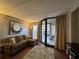 Cozy living room with a comfortable sofa, area rug, and balcony access with seating at 201 N 74Th Ave. N # 2322, Myrtle Beach, SC 29572