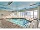Indoor pool area with ample seating, tile flooring, and a blue painted ceiling at 2106 N Ocean Blvd. # 410, Myrtle Beach, SC 29572