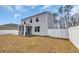 This backyard features a screened porch, a white fence, and an expansive lawn, perfect for outdoor living and entertaining at 220 Forestbrook Cove Circle, Myrtle Beach, SC 29588
