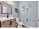 Charming half bathroom featuring a modern vanity, decorative shelves, and a light blue color scheme at 220 Forestbrook Cove Circle, Myrtle Beach, SC 29588