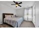 Comfortable bedroom featuring a ceiling fan, large window, and neutral decor at 220 Forestbrook Cove Circle, Myrtle Beach, SC 29588