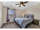 Inviting bedroom with a ceiling fan, plush carpet, and a decorative wrought-iron bed frame at 220 Forestbrook Cove Circle, Myrtle Beach, SC 29588