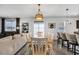 Open dining area featuring a wooden table, stylish lighting, and seamless flow to the living room at 220 Forestbrook Cove Circle, Myrtle Beach, SC 29588