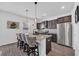 Kitchen showcasing a granite island with seating, dark cabinets, and stainless steel appliances at 220 Forestbrook Cove Circle, Myrtle Beach, SC 29588