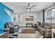 Cozy living room with modern decor, a large ceiling fan, and a bright accent wall at 220 Forestbrook Cove Circle, Myrtle Beach, SC 29588