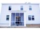 Back of the home with a screened porch, white siding, and plenty of windows at 220 Forestbrook Cove Circle, Myrtle Beach, SC 29588