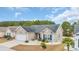 Ariel view of the charming single-story home, featuring a well-manicured lawn, tidy landscaping, and an attached two-car garage at 224 Cupola Dr., Longs, SC 29568