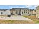 A backyard shows an outdoor patio with grill, chairs, and a spacious yard at 224 Cupola Dr., Longs, SC 29568