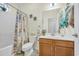 Bathroom with a vanity, toilet, and shower tub combo with a decorative curtain at 224 Cupola Dr., Longs, SC 29568