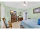 Relaxing bedroom with light green walls, ceiling fan, and comfortable rocking chair at 224 Cupola Dr., Longs, SC 29568