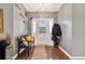 Inviting foyer with wood floors, gray walls, a decorative bench, and chandelier at 224 Cupola Dr., Longs, SC 29568