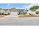 Charming single-story home featuring a well-manicured lawn, tidy landscaping, and an attached two-car garage at 224 Cupola Dr., Longs, SC 29568
