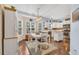 Bright kitchen features white cabinetry, stainless steel appliances, island, and an adjacent dining area at 224 Cupola Dr., Longs, SC 29568