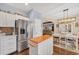 Open kitchen with stainless steel refrigerator and island opens up to a dining area and living room at 224 Cupola Dr., Longs, SC 29568