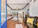 Bright and airy living room with hardwood floors, a tray ceiling, and seamless access to additional rooms at 224 Cupola Dr., Longs, SC 29568