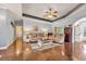 Spacious living room with hardwood floors, comfortable seating, and seamless access to other living spaces at 224 Cupola Dr., Longs, SC 29568