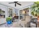 Bright sunroom featuring chair, ottoman, wood paneled walls, large windows and door leading outdoors at 224 Cupola Dr., Longs, SC 29568