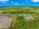 An aerial view captures the property's location amidst lush greenery, fields, and roadways at 2360 Highway 701 North, Loris, SC 29569