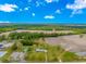 The aerial view captures the house among fields and lush green trees, offering a serene and private setting at 2360 Highway 701 North, Loris, SC 29569