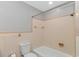 Bathroom with toilet and bathtub with showerhead in a tile surround at 2360 Highway 701 North, Loris, SC 29569