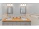Bathroom with double sinks, natural countertop, and two mirrors at 2360 Highway 701 North, Loris, SC 29569