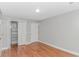 Bedroom with hardwood floors, closet, and neutral paint at 2360 Highway 701 North, Loris, SC 29569