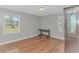 A bedroom with hardwood floors has two windows and a desk at 2360 Highway 701 North, Loris, SC 29569