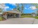 The home's carport features a stained wood ceiling, storage area, and spacious concrete pad at 2360 Highway 701 North, Loris, SC 29569