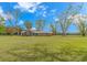 A serene view of the home exterior showcasing its large yard and covered porch at 2360 Highway 701 North, Loris, SC 29569