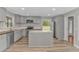 An eat-in kitchen features gray cabinets, stainless appliances, and natural lighting at 2360 Highway 701 North, Loris, SC 29569