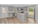 A bright kitchen showcases gray cabinets, stainless appliances, and a center island at 2360 Highway 701 North, Loris, SC 29569